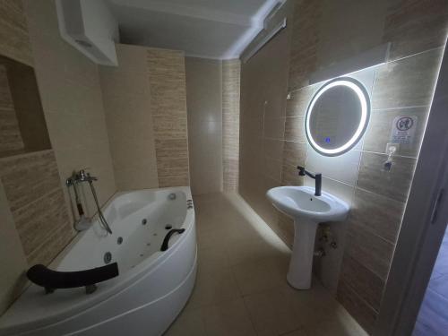 a bathroom with a bath tub and a sink at Z&G Apartment in Bitola
