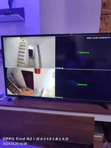 a flat screen tv sitting on top of a desk at Gamgom Studio in Cairo