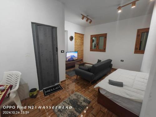 a living room with a bed and a couch at Gamgom Studio in Cairo