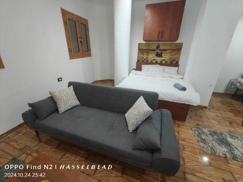 a living room with a couch and a bed at Gamgom Studio in Cairo
