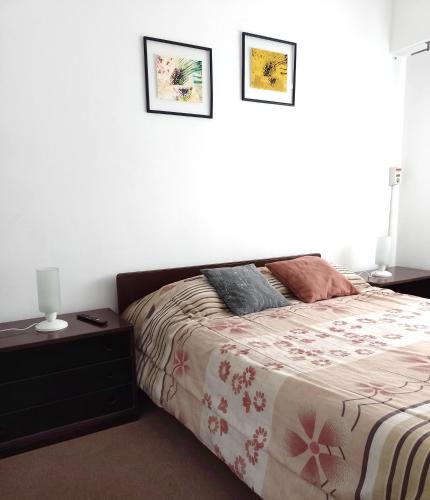 a bedroom with a bed and two pictures on the wall at Amplio y cómodo - Excelente ubicación in Mendoza