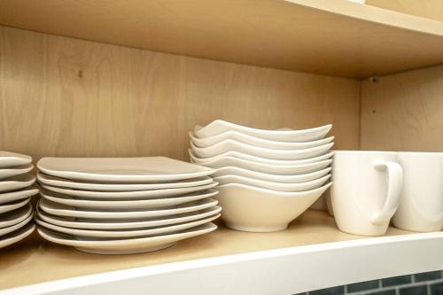 a stack of plates and cups sitting on a shelf at Spacious home with heated pool in Palm Coast! in Palm Coast