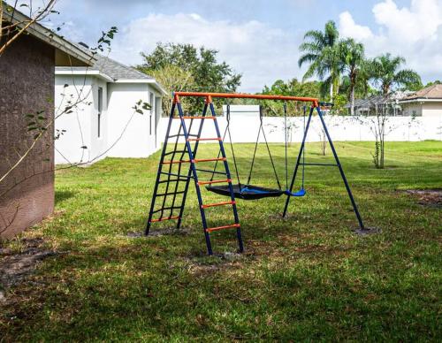 a swing set in a yard with at Spacious home with heated pool in Palm Coast! in Palm Coast