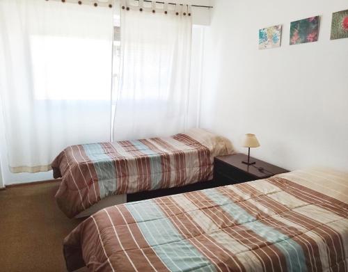 a hotel room with two beds and a window at Amplio y cómodo - Excelente ubicación in Mendoza