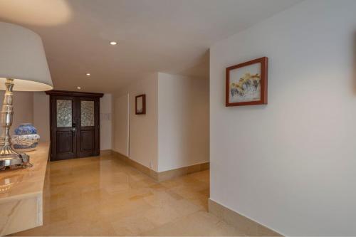 a hallway of a home with a white wall at Presidente InterContinental Puebla by IHG in Puebla