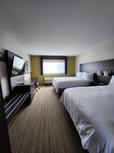 a hotel room with two beds and a flat screen tv at Holiday Inn Express & Suites - Camas by IHG in Camas