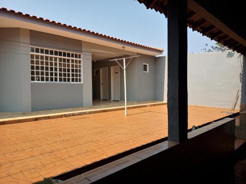 a view of the outside of a house with a patio at Pousada Catarina - 2 in Maringá