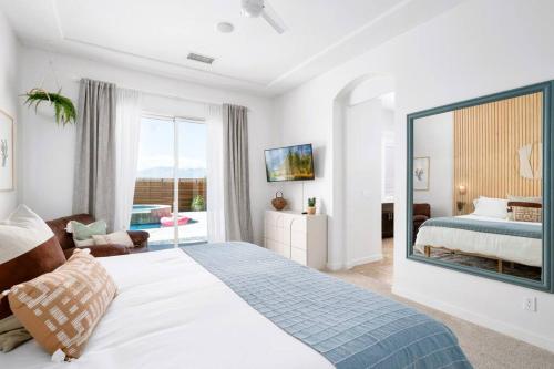 a bedroom with a bed and a large mirror at Golden Sunset- Saltwater Pool & Spa, Putting Green, Firepit, Gameroom in Desert Hot Springs