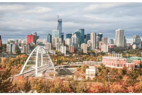 a city skyline with a white bridge in the foreground at The WEM House in Edmonton