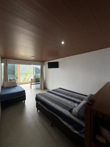 En eller flere senge i et værelse på Casa Bela Vista