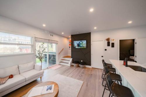 a living room with a couch and a tv at Hot Tub Amazing Location! Modern Ohio City Luxury 2 King Beds in Ohio City