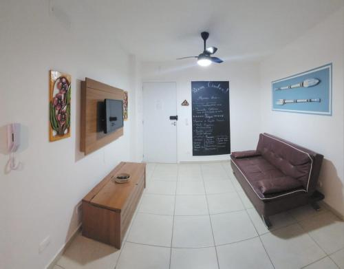 a living room with a couch and a coffee table at Ap Ubatuba in Ubatuba