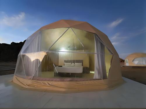 a tent with a bed inside of it at Rum Honeymoon Camp in Wadi Rum