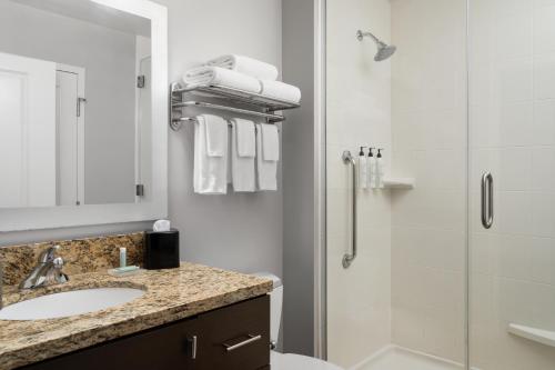 a bathroom with a sink and a shower at TownePlace Suites by Marriott Champaign in Champaign