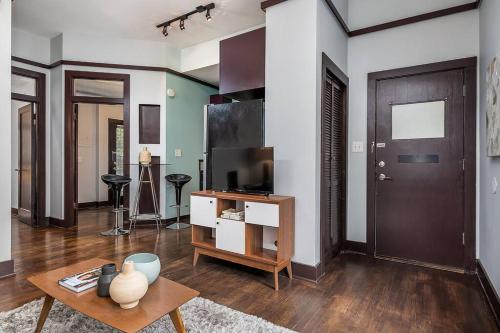 a living room with a television and a table at Cozy Capitol Hill Cottage in Seattle