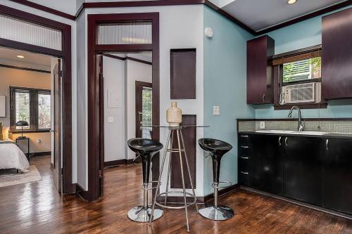 a kitchen with two bar stools in a room at Cozy Capitol Hill Cottage in Seattle