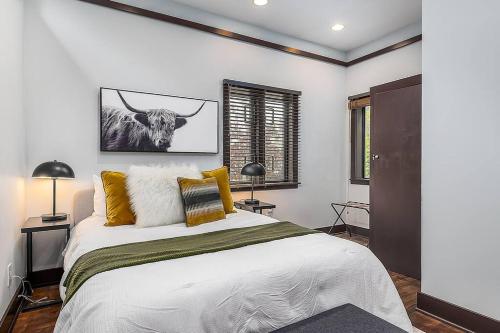 a bedroom with a bed with a bull on the wall at Cozy Capitol Hill Cottage in Seattle