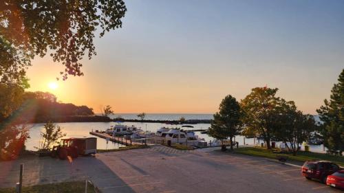 a sunset over a marina with boats in the water at Dreamcatcher Coast House in Essex