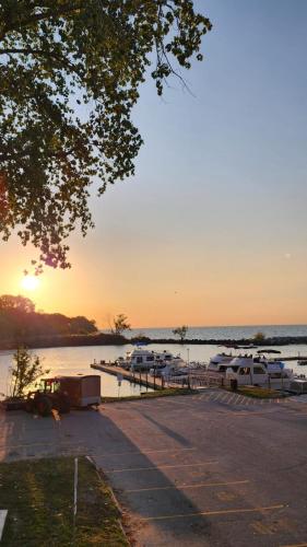 a group of boats parked in a marina at sunset at Dreamcatcher Coast House in Essex