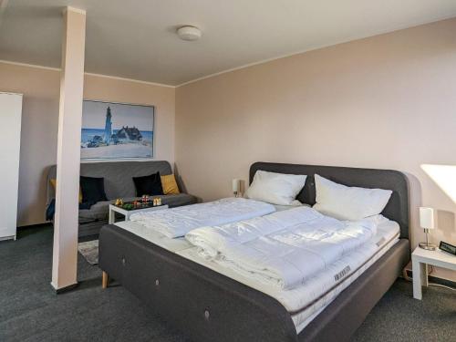 a bedroom with a bed and a living room at Comfortable holiday home in nature in Schönberg