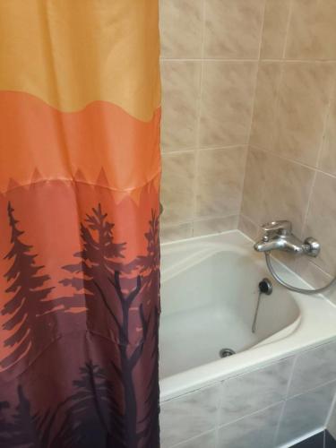 a bathroom with a shower curtain with trees on it at Champion Hotel in Taipei