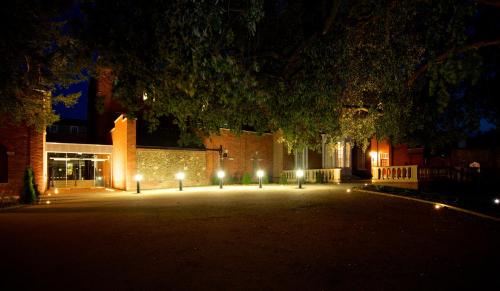 a building with lights in front of it at night at GreyFriars in Colchester