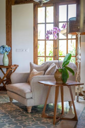 a living room with a couch and a table at Umah Lusa in Munduk