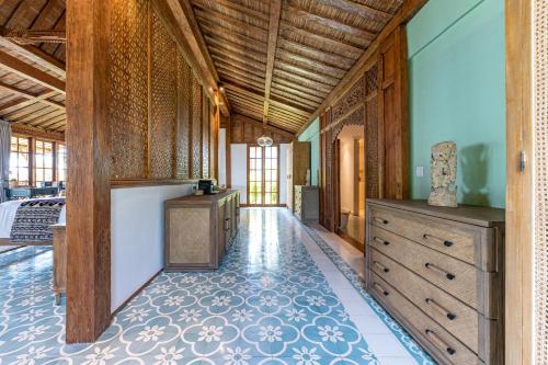 a large hallway with a dresser and a room at Umah Lusa in Munduk