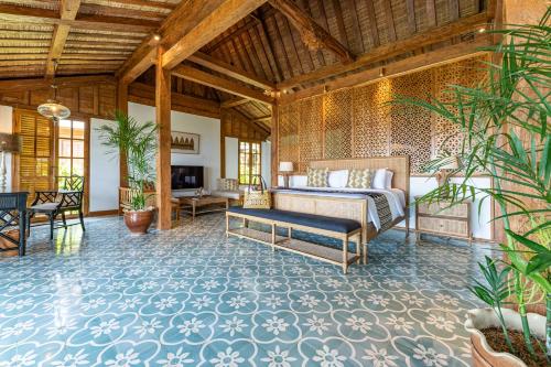 a living room with a bed and a couch at Umah Lusa in Munduk