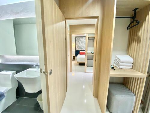 a bathroom with a sink and a toilet in a room at Bangkok Mystay Hotel Rangsit in Thanya Buri
