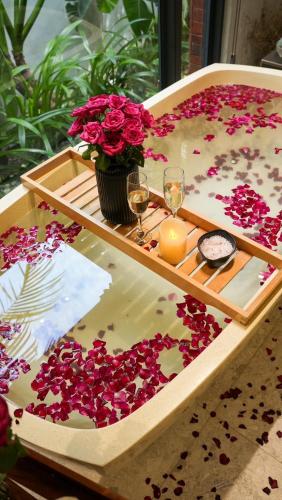a table with flowers and wine glasses on it at Flowering Villa in Xiaoliuqiu