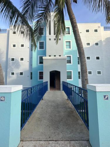 a building with palm trees in front of it at La Costa View in Ceiba