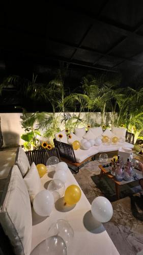 a table with white couches and yellow balloons on it at Flowering Villa in Xiaoliuqiu