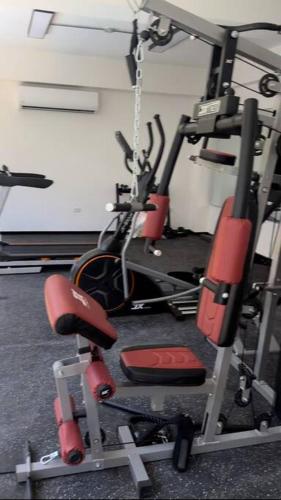 a gym with several exercise bikes in a room at Brand New Beachfront Sunset Apartments in San Felipe de Puerto Plata