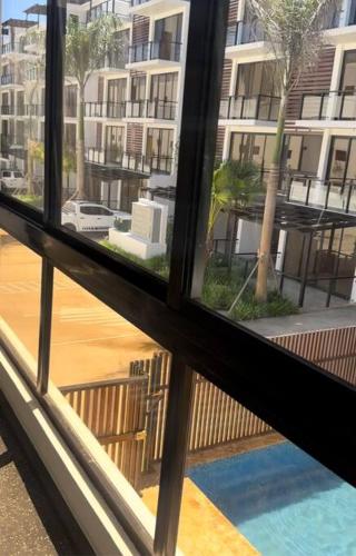 a view from a window of a building at Brand New Beachfront Sunset Apartments in San Felipe de Puerto Plata
