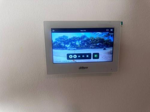 a television on a wall with a video game on it at Brand New Beachfront Sunset Apartments in San Felipe de Puerto Plata