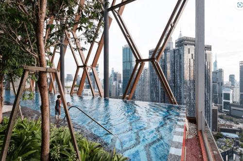 a swimming pool on the roof of a building at Scarletz Suites KLCC in Kuala Lumpur
