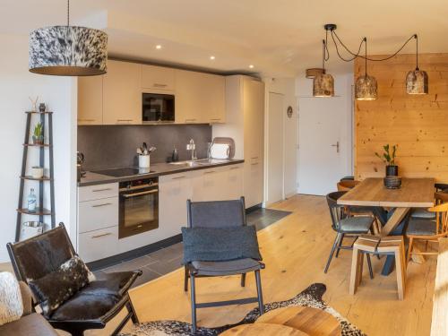 une cuisine et une salle à manger avec une table et des chaises dans l'établissement Bel appartement T3 en résidence neuve avec parking et WIFI, proche du village et ski-bus - FR-1-624-168, à Samoëns
