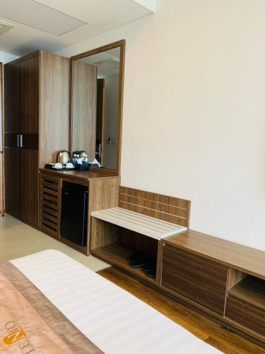 a kitchen with wooden cabinets and a mirror at Lenid Ocean View Hotel in Nha Trang