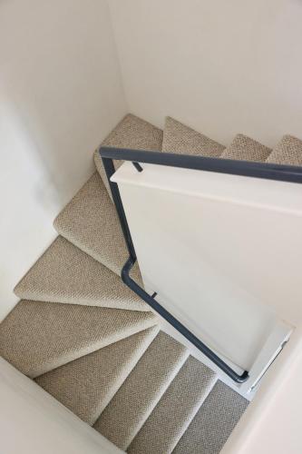 a set of stairs with a white box on it at Waterfront home with outdoor spa bath and mountain views - 5 min drive to city in Montagu Bay