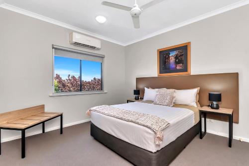 a bedroom with a bed and a window at Comfort Inn & Suites Karratha in Karratha