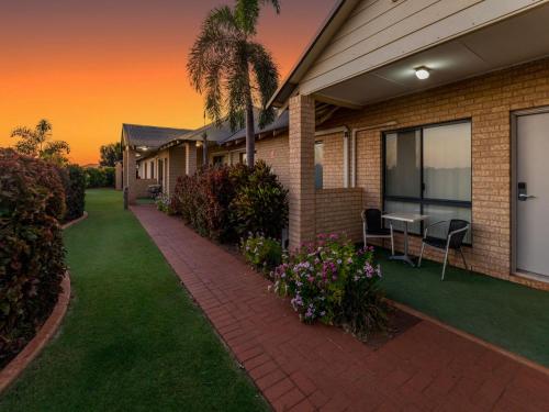 a house with a patio and a table and chairs at Comfort Inn & Suites Karratha in Karratha