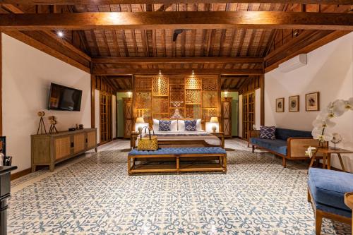 a living room with a bed and a couch at Umah Lusa in Munduk