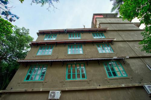 a building with green windows on the side of it at Hotel Sea Castle in Calangute