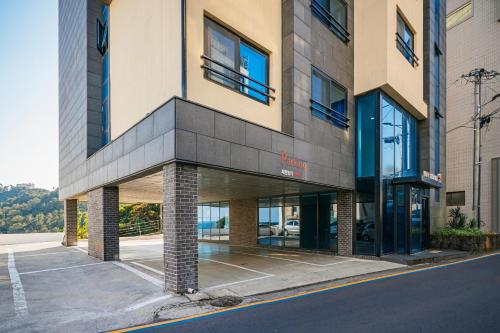 a building on the side of a street at Hotel Yeon in Seogwipo