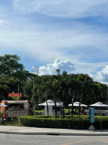 a street with palm trees and tents in a park at Exec 1BR One Manchester Place with pool, beach pass is P 350 pp in Punta Engaño