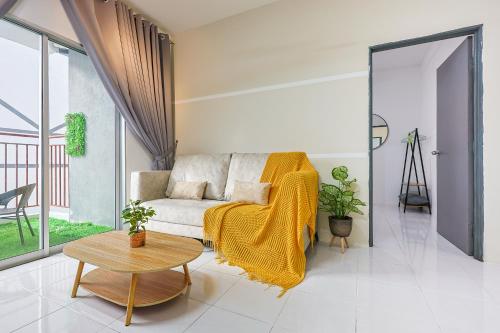 a living room with a couch and a table at Premium Family Homestay in Cameron Highlands Clover Home 1-06 in Brinchang