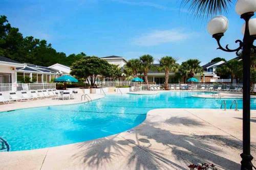 a large swimming pool with blue water at Amazing Newly Renovated Condo at Sea Trail Resort in Sunset Beach
