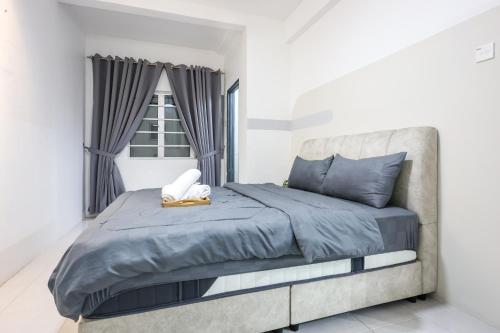a bedroom with a bed with blue sheets and a window at Premium Family Homestay in Cameron Highlands Clover Home 1-06 in Brinchang