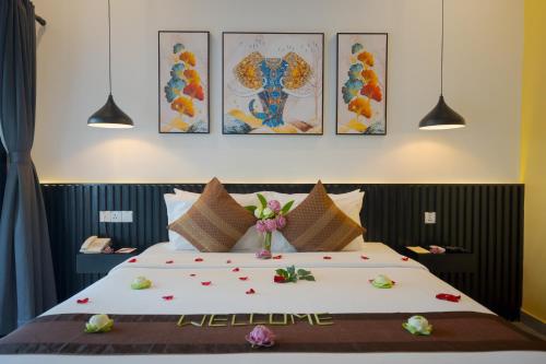 a bedroom with a large bed with flowers on it at Khmer Mansion Boutique Hotel in Siem Reap